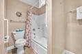 Unwind in your pristine bathroom featuring a relaxing tub-shower combo, plus fresh towels and thoughtful coastal touches for your comfort.