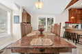 Gather around this stunning wood dining table where your group can share memorable meals together in the open-concept space.