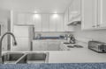 This bright, fully equipped kitchen has everything you need to whip up your favorite meals. Enjoy ample counter space, modern appliances, and plenty of storage to make your stay feel like home.