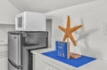 Your compact kitchen features modern appliances and coastal touches, creating a perfect space for preparing meals during your beach getaway.