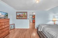 Your cozy bedroom features warm wood floors, peaceful artwork, and comfortable furnishings that create the perfect retreat after your adventures.