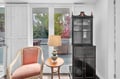 Your elegant reading nook awaits with plush seating and warm lighting, perfectly positioned by garden windows for peaceful moments.