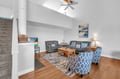 Sink into plush seating with soaring ceilings and coastal artwork creating your perfect retreat for evening relaxation.