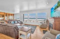 Watch waves crash from your oceanfront living room, where plush seating and a cozy fireplace create the perfect spot to unwind.
