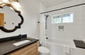 Unwind in your pristine bathroom with a luxurious soaking tub and modern amenities for ultimate comfort.