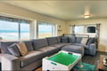 Sink into the spacious sectional and take in sweeping ocean views through oversized windows. Your coastal escape awaits with a bright, airy living room designed for relaxation.