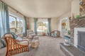 Relax in your bright living room with coastal views, cozy fireplace, and comfortable seating perfect for unwinding after exploring.
