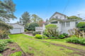 Charming weatherboard home nestled in peaceful residential neighborhood with mature trees and established gardens creating a tranquil setting.