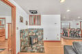 Gather around your cozy fireplace with beautiful tile surround, connecting the living and dining areas in warm comfort.