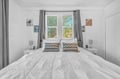 Sink into crisp white linens and enjoy peaceful garden views from your bright, airy bedroom retreat.