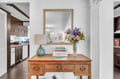 Your elegant kitchen flows seamlessly into stylish living spaces, featuring warm wood details and thoughtful touches that make cooking and entertaining feel effortless.