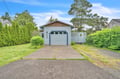 Charming coastal cottage with convenient parking and easy access to your getaway surrounded by trees and greenery.