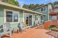 A coastal retreat set against mature trees and clear skies, offering peaceful outdoor spaces to unwind in the fresh air.