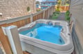 Soak your worries away in your private hot tub on the deck, surrounded by lush gardens and peaceful neighborhood views.