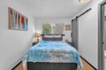 Drift into restful sleep in this thoughtfully designed bedroom, where warm wood accents, soft lighting, and coastal-inspired bedding invite you to unwind after your adventures.