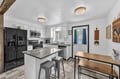 Fully equipped kitchen with modern appliances, sleek countertops, and a cozy dining area where you can gather for meals and plan your adventures.