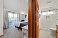 Your private suite features a cozy bedroom with balcony access and connecting bathroom for ultimate convenience and comfort.