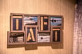 A thoughtful display welcomes you with framed photos spelling out 'DAD', showcasing local landmarks and serene water scenes from the surrounding area.