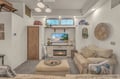 Sink into plush seating and unwind in your coastal-inspired living space, where warm textures and beach-themed touches create your perfect home away from home.