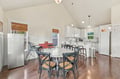 Gather around this spacious kitchen with vaulted ceilings and plenty of room to cook, dine, and share stories. Natural light pours through bamboo shades, and gleaming appliances await your favorite recipes.
