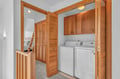 Your dedicated laundry space features a full-size washer and dryer, tucked away behind beautiful louvered doors for convenience and style.