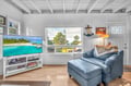 Unwind in your cozy living space with a plush leather chair and large TV for movie nights after exploring.