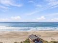 This beachfront property offers direct access to pristine sandy shores and sweeping ocean views. The small structure sits right on the beach, providing an ideal coastal retreat.