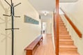 Step into your welcoming entryway, where warm wood tones and thoughtful touches greet you at the door—your home away from home begins here.