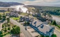 Coastal retreat nestled between rolling hills and pristine beaches, where river meets ocean in perfect harmony.