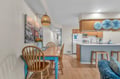 Your bright open-concept dining and kitchen space features coastal touches and warm wood finishes perfect for family meals.