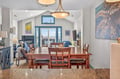Gather around your elegant dining table where warm wood meets coastal charm, perfect for memorable meals with loved ones.