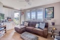 Sink into this comfortable sectional while enjoying stunning water views through expansive windows. Your perfect retreat for movie nights and relaxation.