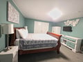 Unwind in your serene bedroom featuring a plush sleigh bed, calming coastal colors, and modern amenities including a TV for cozy nights.