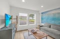 Unwind in your bright living room with coastal wave art and a flat-screen TV, perfect for movie nights and relaxing after adventures.