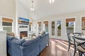 Curl up with your favorite book or gather for conversation in this bright, airy living space. Vaulted ceilings, a cozy fireplace, and French doors opening to a private deck create the perfect retreat after exploring the coast.