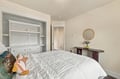 Slip into your peaceful retreat where a plush bed awaits and clever built-in storage keeps everything tidy. The warm wood accents and cozy textiles create a welcoming atmosphere for your restful escape.