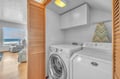 Your dedicated laundry space keeps your vacation wardrobe fresh, with modern washer and dryer tucked behind elegant wood panels.