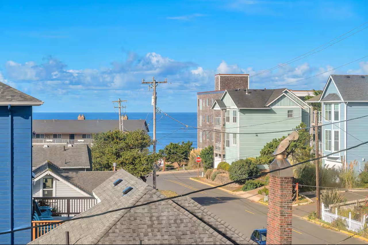 A charming coastal neighborhood where residential streets slope gently toward the Pacific Ocean. The property offers a peaceful setting with glimpses of the sea between nearby homes.
