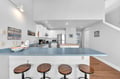 Your bright, open kitchen awaits with modern appliances and a breakfast bar perfect for morning coffee or casual dining.