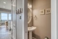 Step into your coastal-inspired powder room with nautical charm and elegant touches for your comfort.