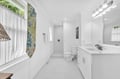 Refresh in your bright, modern bathroom with subway tile shower and elegant vanity.
