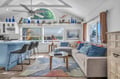 Relax in your bright, airy living space with vaulted ceilings, coastal decor, and colorful pillows inviting you to unwind.