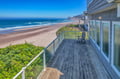 Step onto your private deck and savor morning coffee while watching waves roll onto pristine shores below.