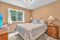 Settle into your peaceful bedroom with warm tones, soft linens, and lush garden views through bright windows.