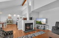 Unwind by your cozy fireplace while watching TV, with warm wood floors and high ceilings creating the perfect atmosphere for relaxation.