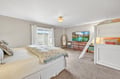 Unwind in your spacious bedroom featuring a queen bed, bunk beds for extra guests, and mountain lake artwork.