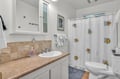 Your bright bathroom features a whimsical fish-themed shower curtain, fresh towels, and thoughtful amenities to make your stay comfortable.
