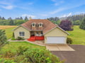 A charming countryside retreat set on spacious grounds, with rolling hills and lush forests creating a peaceful backdrop perfect for your escape.