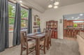 Step into your welcoming dining space where natural light pours through tall windows, perfect for sharing meals around the wooden table and creating memories with loved ones.