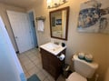 Refresh in your private bathroom featuring coastal sea turtle artwork, plush towels, and thoughtful amenities for your comfort.